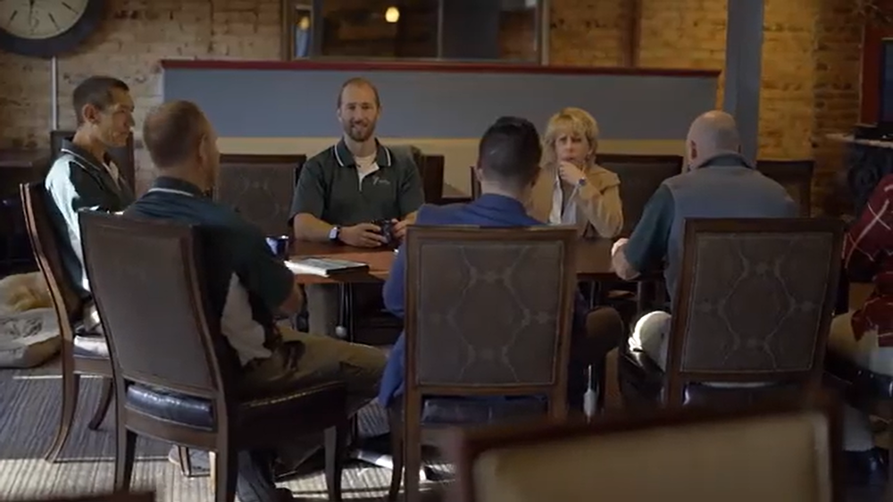 Cyndi Gave speaking with clients at conference table