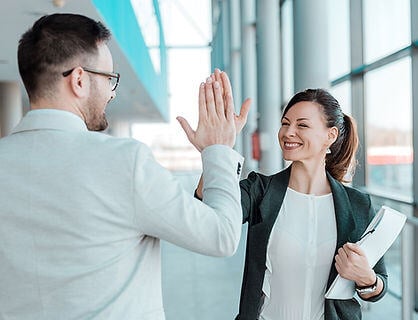 Employees giving each other a high five