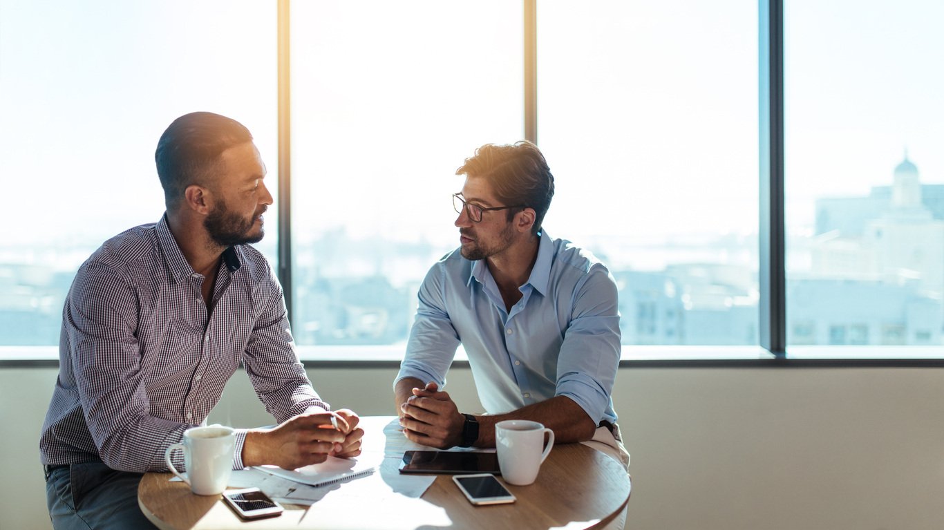 Two business leaders having meeting over coffee