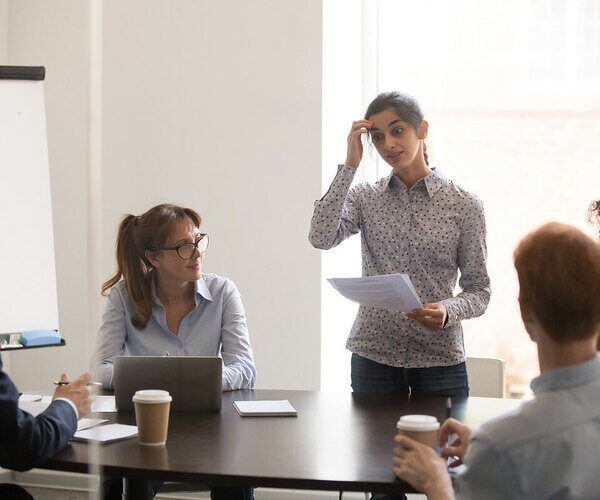 A wrong person for leadership development stands awkwardly at a conference table