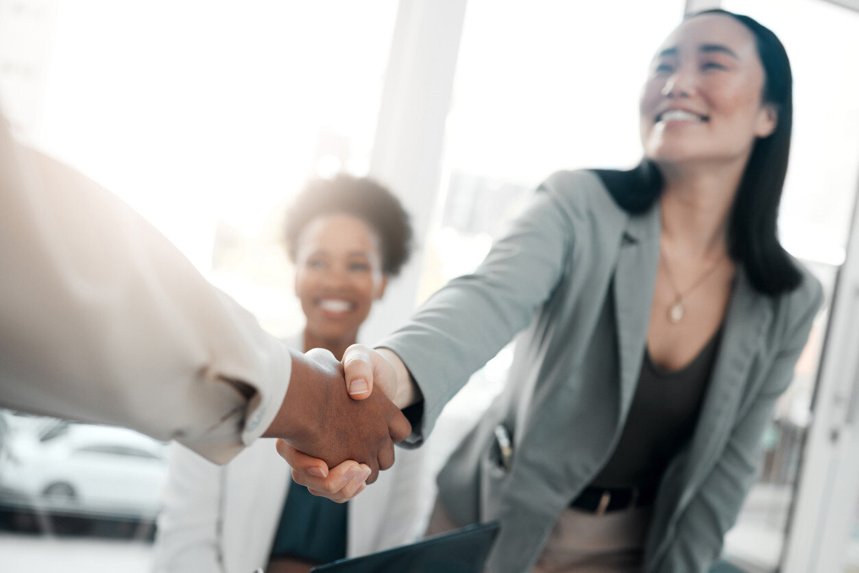 Hiring manager shaking hand of new hire employee