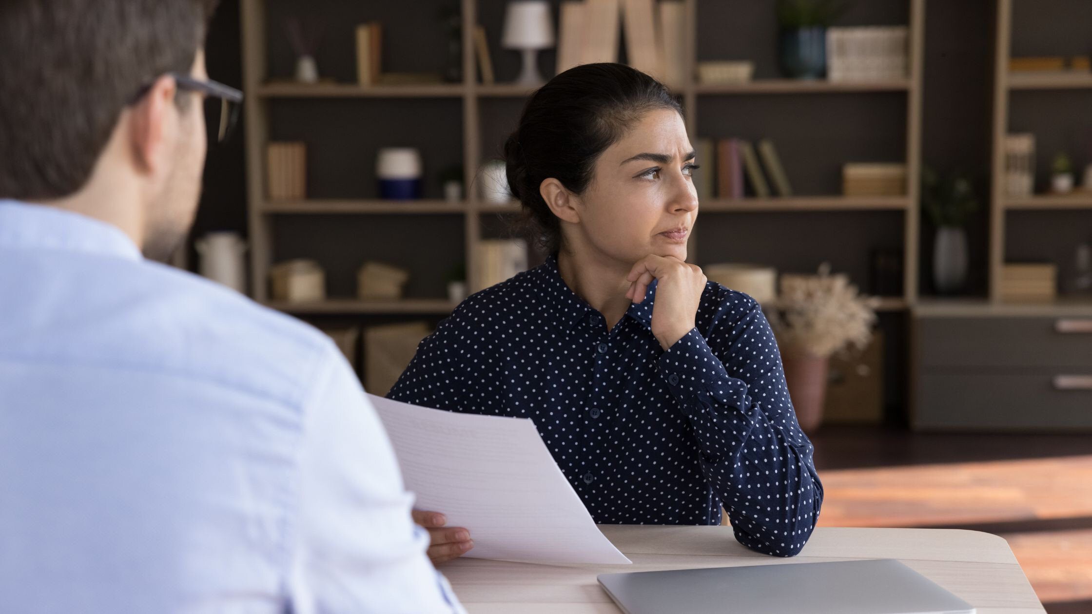 Hiring manager frustrated while looking at resume