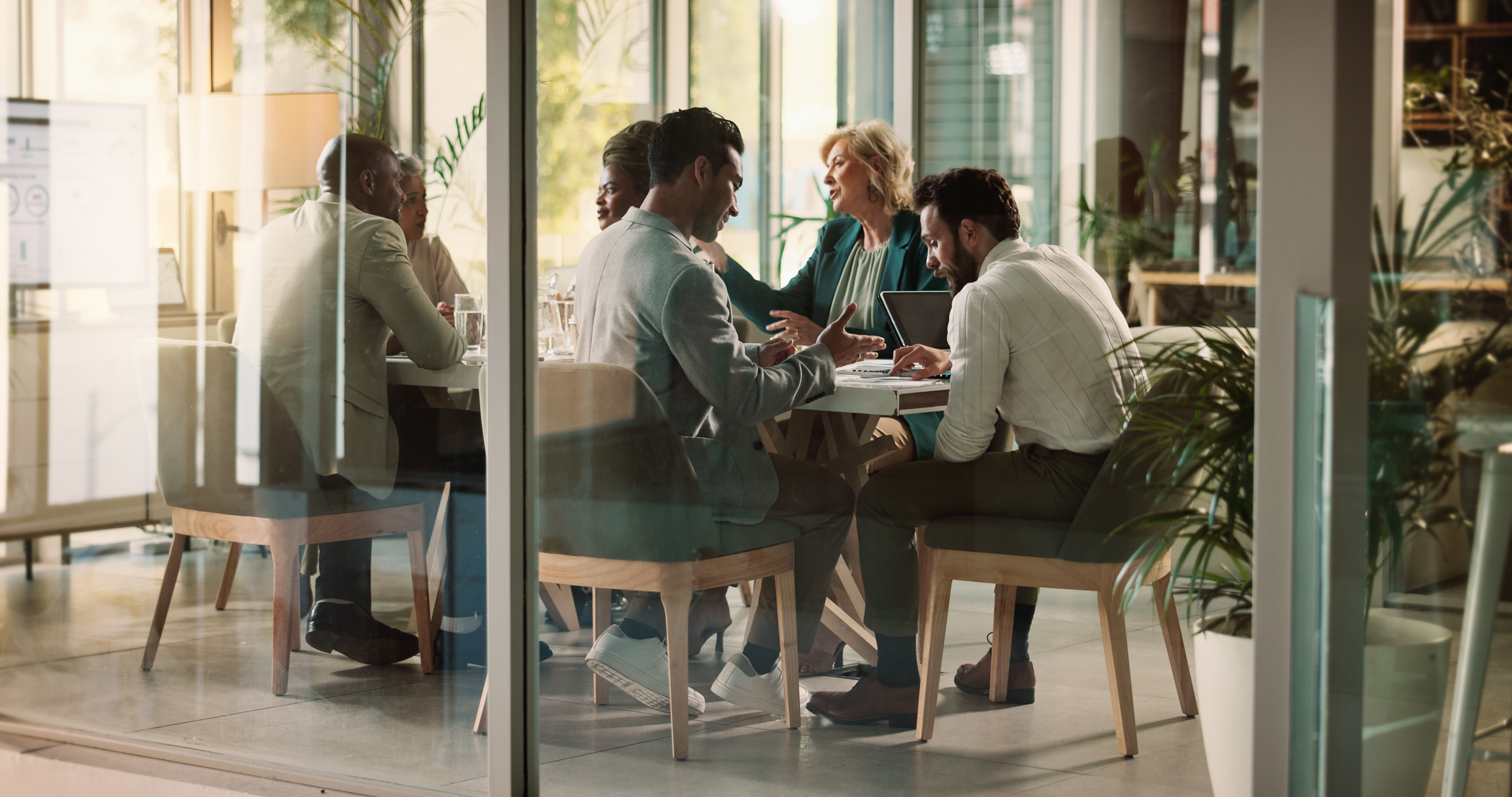 Leaders having meeting at conference table discussing the 2025 leadership trends